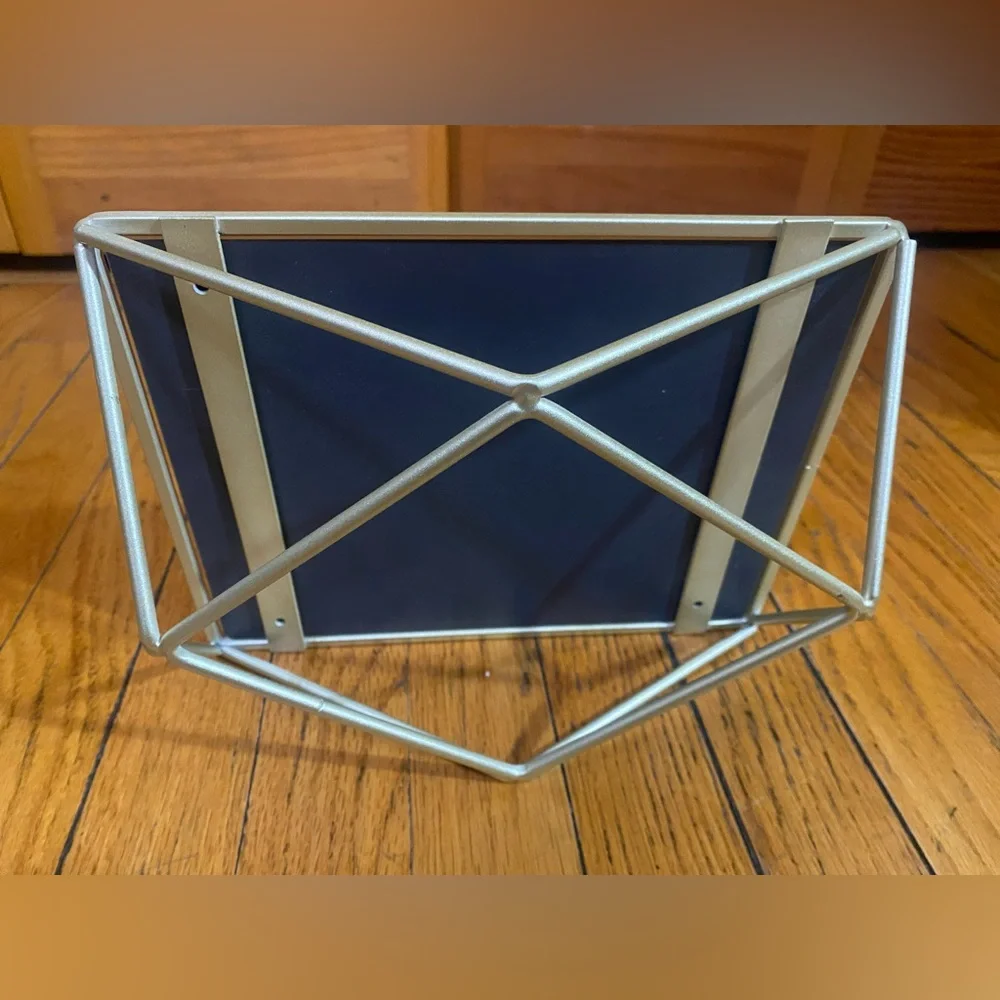 Mirror with geometric metalwork